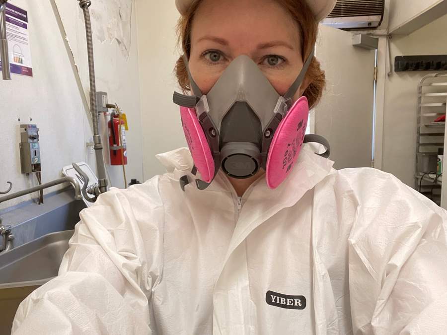 woman with protective construction suit and mask