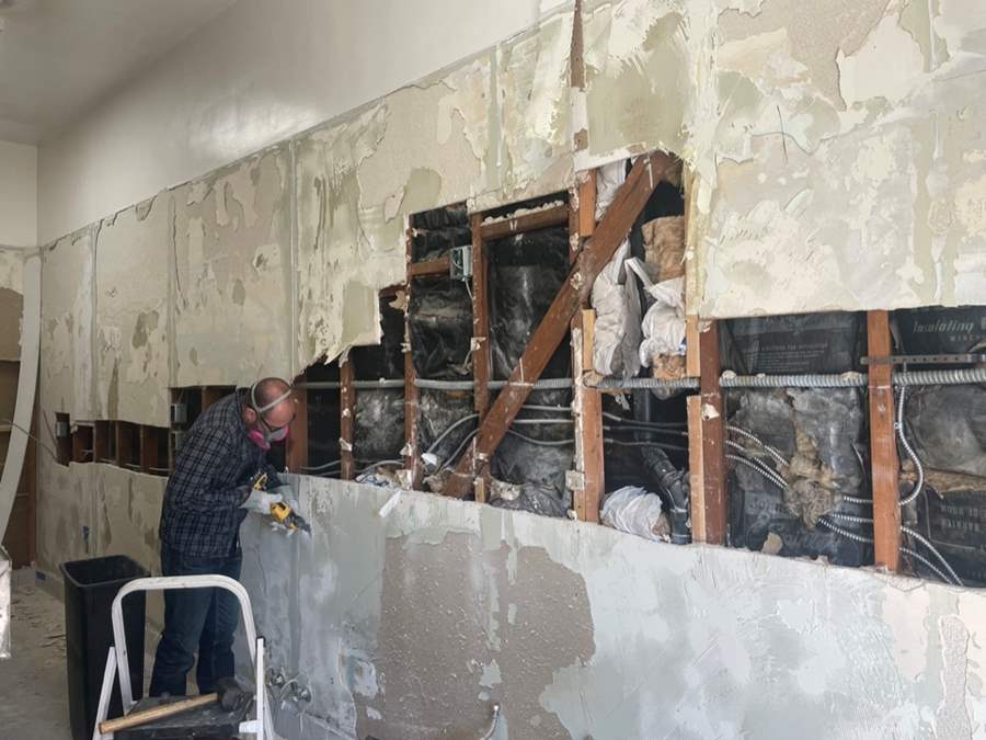 man demoing wall